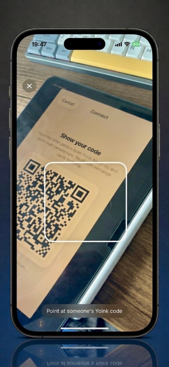 Scanning a friend's Yoink QR code with the phone camera to start the swap.